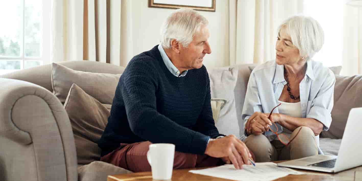 Older couple talking together at home